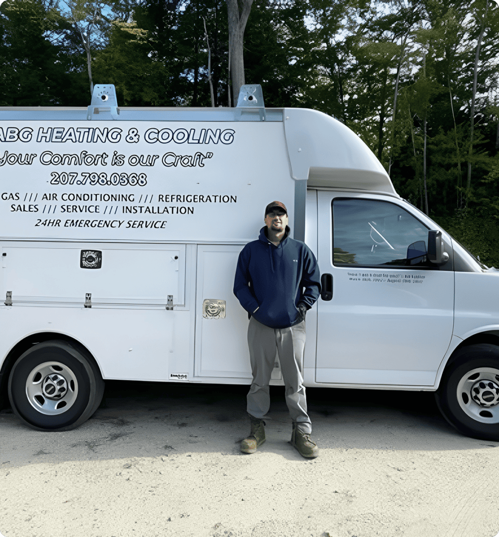 Technician standing beside white HVAC service van