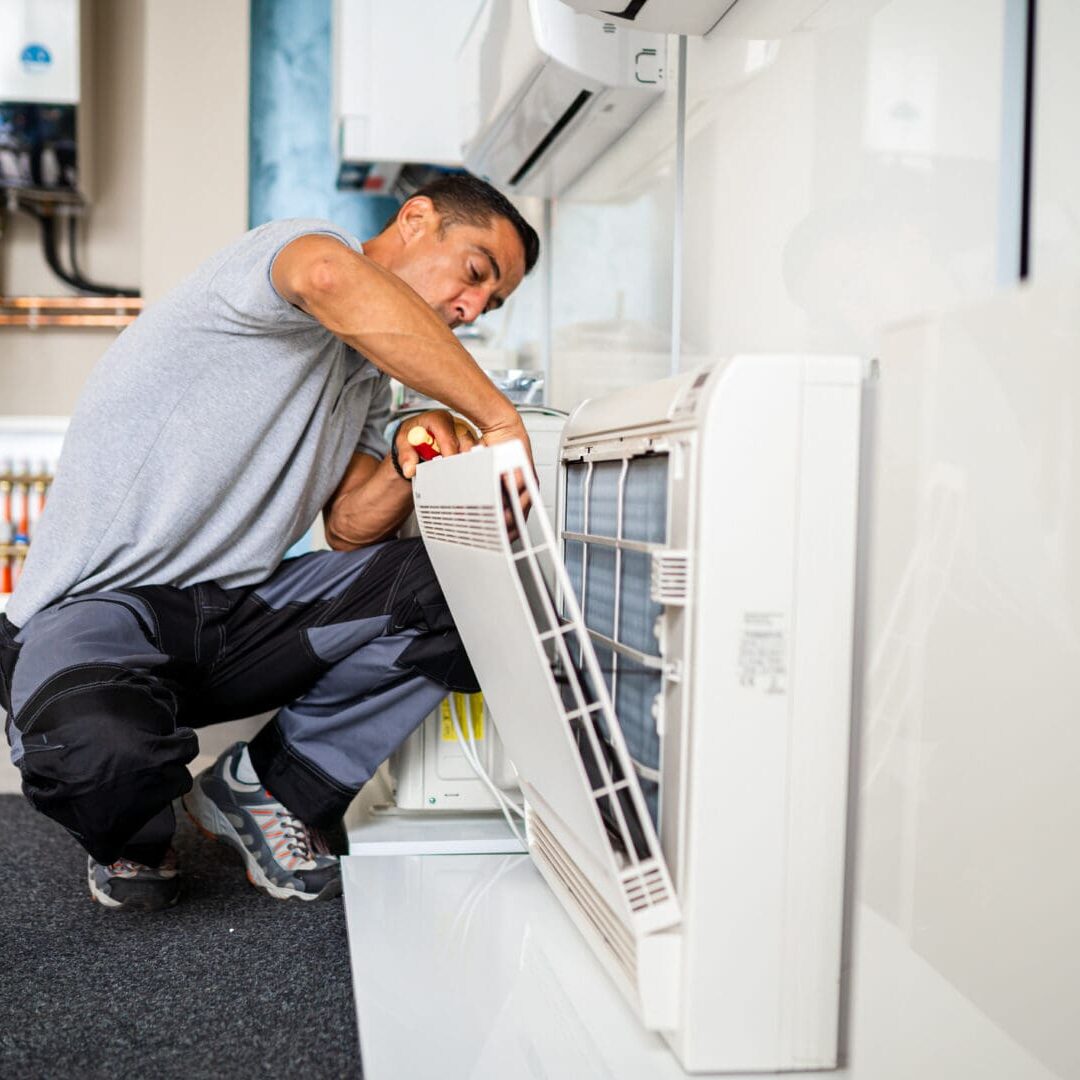 Technician repairing air conditioning unit